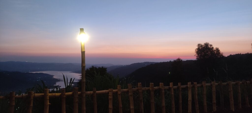 Two-story camping tower with tents at sunrise overlooking scenic valley at Yuva Yatri Campsite, Mahabaleshwar.